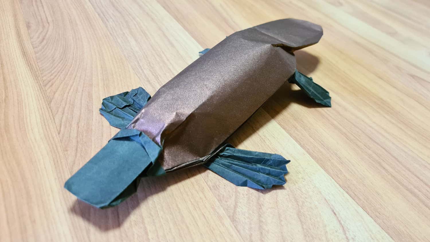 A folded origami platypus model, viewed from the front